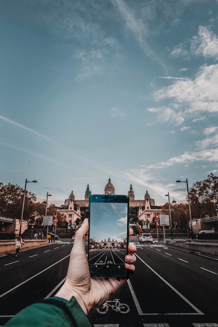 A mobile phone captures the stunning facade of Barcelona's National Art Museum.